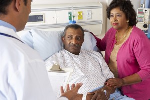 Doctor Talking To Senior Couple, Patient On Ward